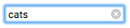 Fokussiertes Sucheingabefeld, mit Fokusring, mit dem Text 'cats'. Es gibt ein x-Symbol in der Eingabe, das die rechte Seite begrenzt.