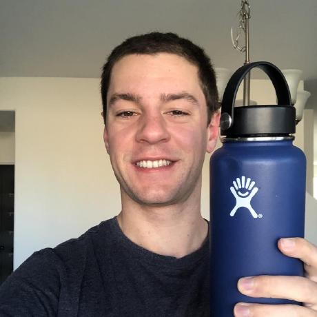 Tanner Dolby smiling and holding a water bottle in his right hand